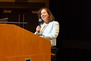 Jennifer Fraone speaking at podium